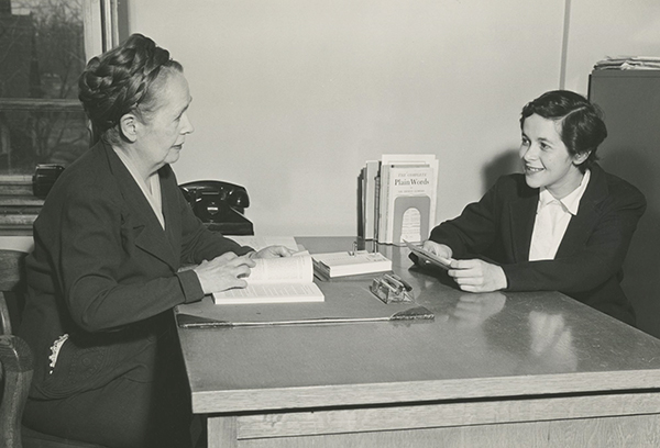 MacInnes meets with a student in the Registar's Office.